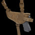 The Condor Universal Shoulder Holster in tan features adjustable straps, secure snap closures, and holds a black pistol securely.